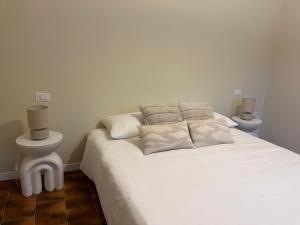 a bedroom with a white bed with two night stands at Casa Nina in Valbravenna