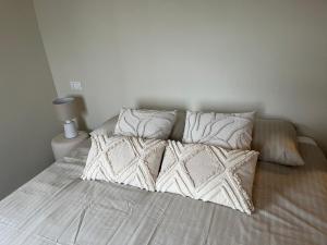 a bed with white sheets and pillows in a bedroom at Casa Nina in Valbravenna