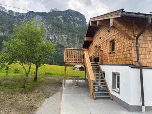 a house with a wooden staircase on the side of it at Ferienwohnung Loifried in Abtenau