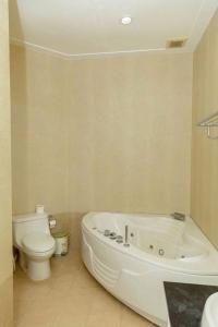 a bathroom with a white tub and a toilet at Villa Seaview S15 in Ấp Phú Tịnh (2) +17 photos