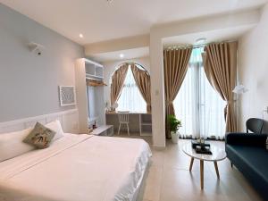 a bedroom with a large bed and a living room at Santo house in Thôn Trường Giang