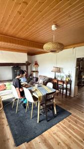 a man sitting at a table in a living room at Quinta Da Carvalheira Regenerative Coliving in Soure