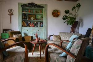 a living room with a couch and a table at Quinta Da Carvalheira Regenerative Coliving in Soure