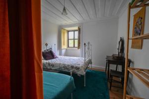 a small bedroom with a bed and a window at Quinta Da Carvalheira Regenerative Coliving in Soure +35 photos