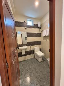 a bathroom with a toilet and a sink at Thamira Grand palace in Agastīswaram