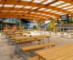 a group of tables and benches in a building at Newquay - Deluxe 3 bed Lodge Willows Way 47, Newquay Parkdean, Holiday Park in Newquay