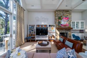 a living room with a couch and a fireplace at 2251 Catesby's Bluff in Seabrook Island