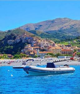 a boat sitting in the water near a beach at Stefy's House in Scalea