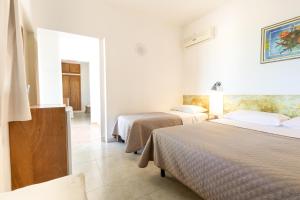 a hotel room with two beds and a window at San Carlo - Terrazzo sul Mare con Ristorante e Pizzeria in Zambrone