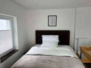 a bedroom with a bed with a black headboard at Amara in Siegburg