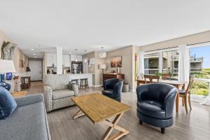 a living room with a couch and chairs and a table at 1325 Pelican Watch Villa in Seabrook Island
