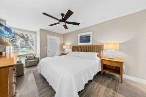 a bedroom with a bed and a ceiling fan at 1325 Pelican Watch Villa in Seabrook Island +18 photos