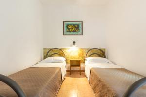 a room with three beds and a table in it at San Carlo - Terrazzo sul Mare con Ristorante e Pizzeria in Zambrone +34 photos