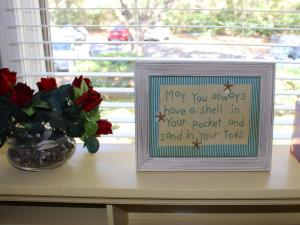 a picture in a frame next to a vase of flowers at 1317 Pelican Watch Villa in Seabrook Island