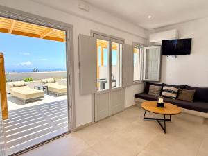 a living room with a view of the ocean at Nohēme Luxury Suites in Vourvoúlos