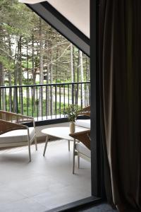 a view of a porch with a table and chairs at Hotel Dom in Studenci