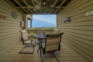 a patio with a table and chairs on a porch at 1317 Pelican Watch Villa in Seabrook Island