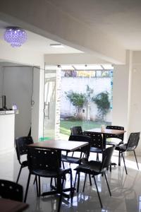 a dining room with tables and chairs and a window at Hotel Ullanka in Encarnación