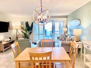 a dining room and living room with a table and chairs at 1391 Pelican Watch Villa in Seabrook Island +24 photos