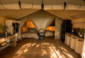 a bedroom with a bed in a tent at Camping de Retourtour in Lamastre