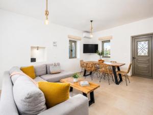 a living room with a couch and a table at Villa Castillo Ena in Agios Nikolaos