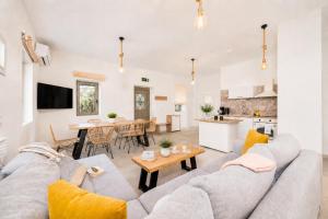 a living room with a gray couch and a table at Villa Castillo Ena in Agios Nikolaos