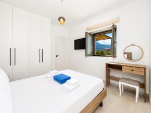 a bedroom with a bed and a desk and a window at Villa Castillo Ena in Agios Nikolaos +15 photos