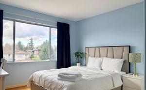 a bedroom with a bed with a large window at Private Ensuite Room Near YVR Airport Vancouver West in Vancouver