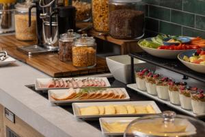 a buffet with different types of food on a counter at Aloft by Marriott Belfast Titanic Quarter in Belfast