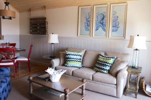 a living room with a couch and a table at 13106 Pelican Watch Villa in Seabrook Island