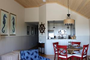 a living room with a table and chairs and a kitchen at 13106 Pelican Watch Villa in Seabrook Island +19 photos