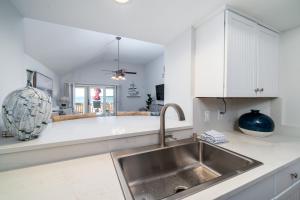 a kitchen with a sink and white cabinets at 1306 Pelican Watch Villa in Seabrook Island