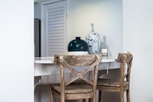 a chair at a table with a vase on it at 1306 Pelican Watch Villa in Seabrook Island