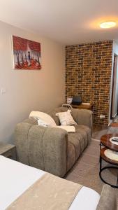 a living room with a couch and a table at Pinnacle Homes 254 - Ruaka in Ruaka +2 photos