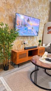 a living room with a flat screen tv on a wall at Pinnacle Homes 254 - Ruaka in Ruaka