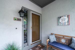 a porch with a blue bench next to a door at 2501 Chateau by the Green in Seabrook Island