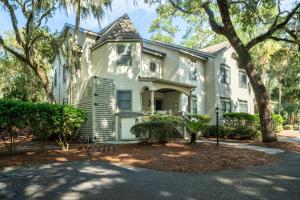 a white house with trees in front of it at 2501 Chateau by the Green in Seabrook Island