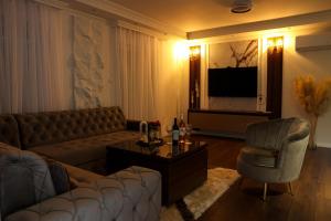 a living room with a couch and a television at Apartman Lux Bileca in Bileća