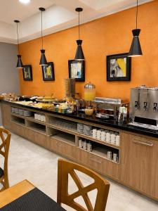 a kitchen with a counter with food on it at Filadelfia Hotel in São Paulo +27 photos