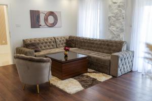 a living room with a couch and a coffee table at Apartman Lux Bileca in Bileća