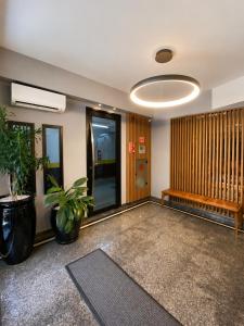 a lobby with a plant and a bench in a building at Filadelfia Hotel in São Paulo