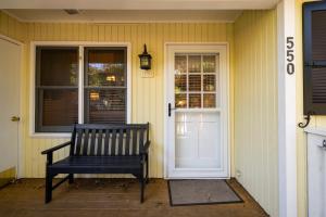a bench sitting on the front porch of a house at 550 Tarpon Pond Cottage in Seabrook Island