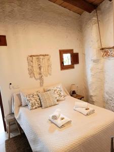 a bedroom with a bed with two towels on it at Ca La Portella in Jávea