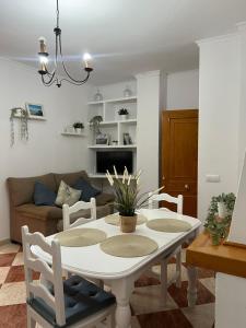 a living room with a white table and chairs at Casas PARAJE NATURAL in Zahara de la Sierra
