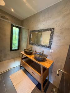 a bathroom with two sinks and a mirror at Casa Avvena 1 in Lecci