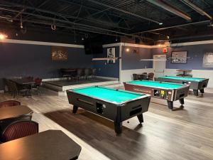 a ping pong room with two pool tables at Wheatland Hotel in Strathmore