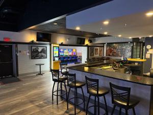 a bar in a restaurant with stools at a counter at Wheatland Hotel in Strathmore