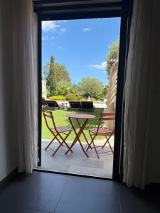 a patio with a table and two chairs outside at Casa Avvena 1 in Lecci