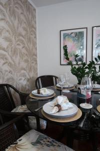 a dining room table with plates of food on it at Halia in Gold Coast