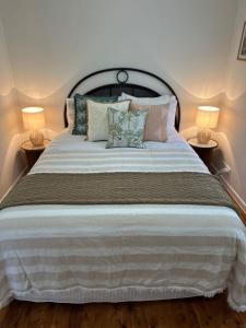 a bedroom with a large bed with two lamps at Halia in Gold Coast
